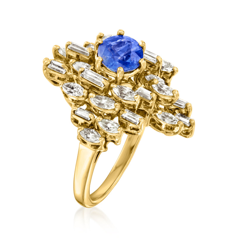 Side view of 18k yellow gold cocktail ring with blue sapphire center and baguette clear stones