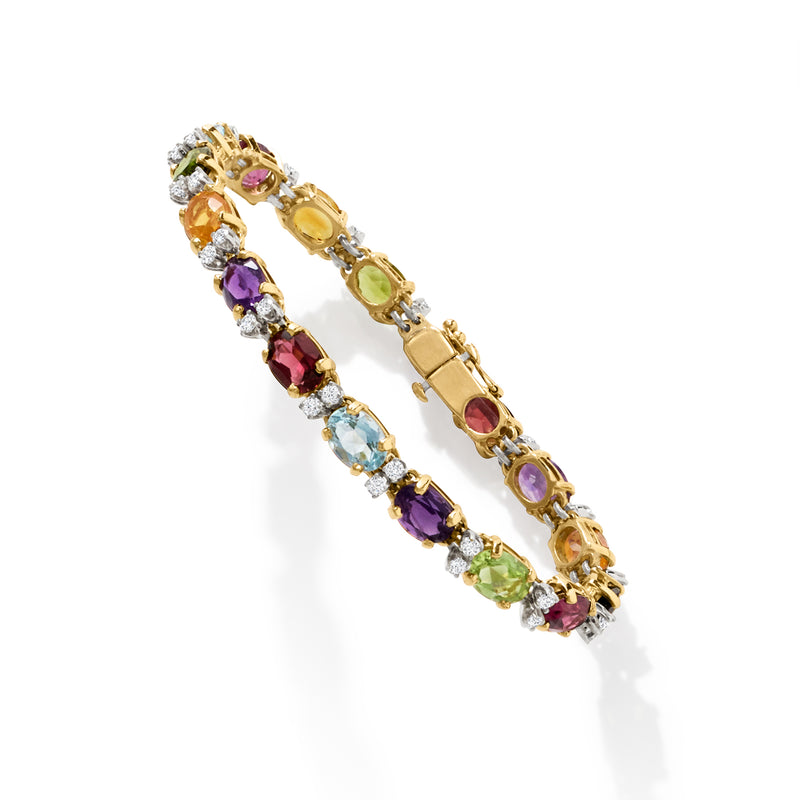 Side view yellow gold multi-gemstone bracelet with oval and round colored gemstones