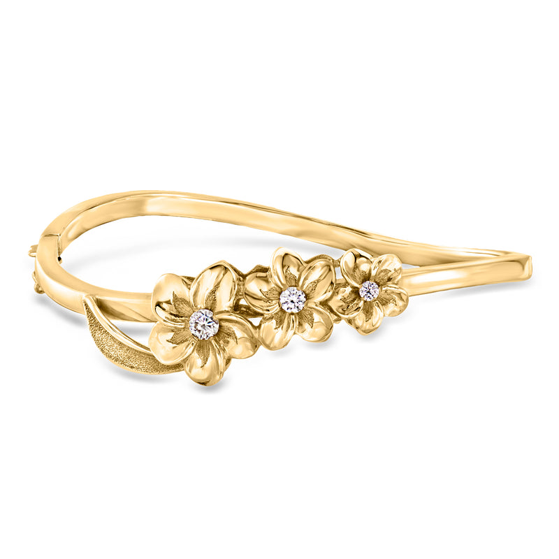14kt yellow gold bangle bracelet with three diamond flower clusters, hinged cuff