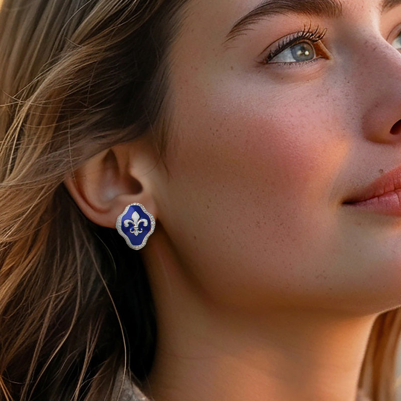 Blue enamel fleur-de-lis stud earrings with clear CZ halo, worn by model