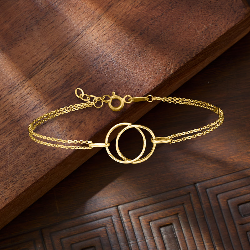 Gold double-circle bracelet featuring two linked circular charms and chain links