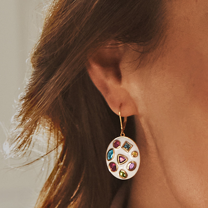 Gold leverback drop earrings with white enamel round and assorted gemstone accents