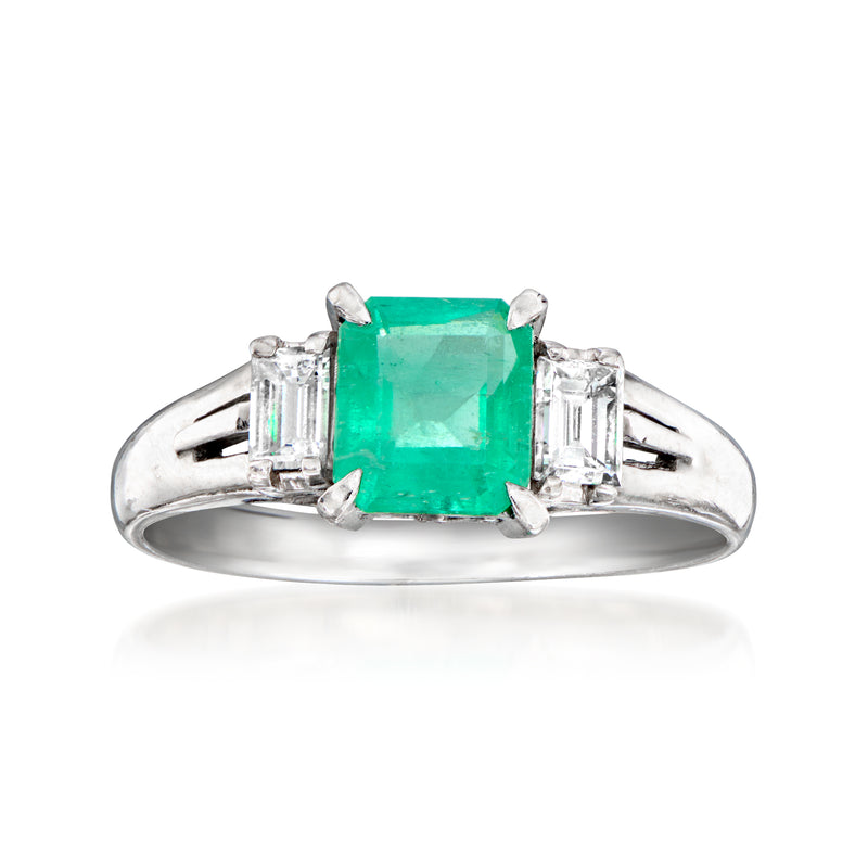 Vintage platinum ring with emerald-cut green gemstone center and baguette diamond side stones