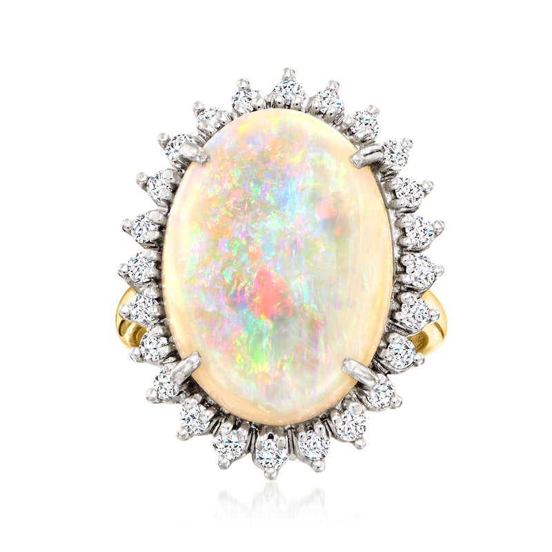 Oval opal cabochon ring in two-tone gold with diamond halo