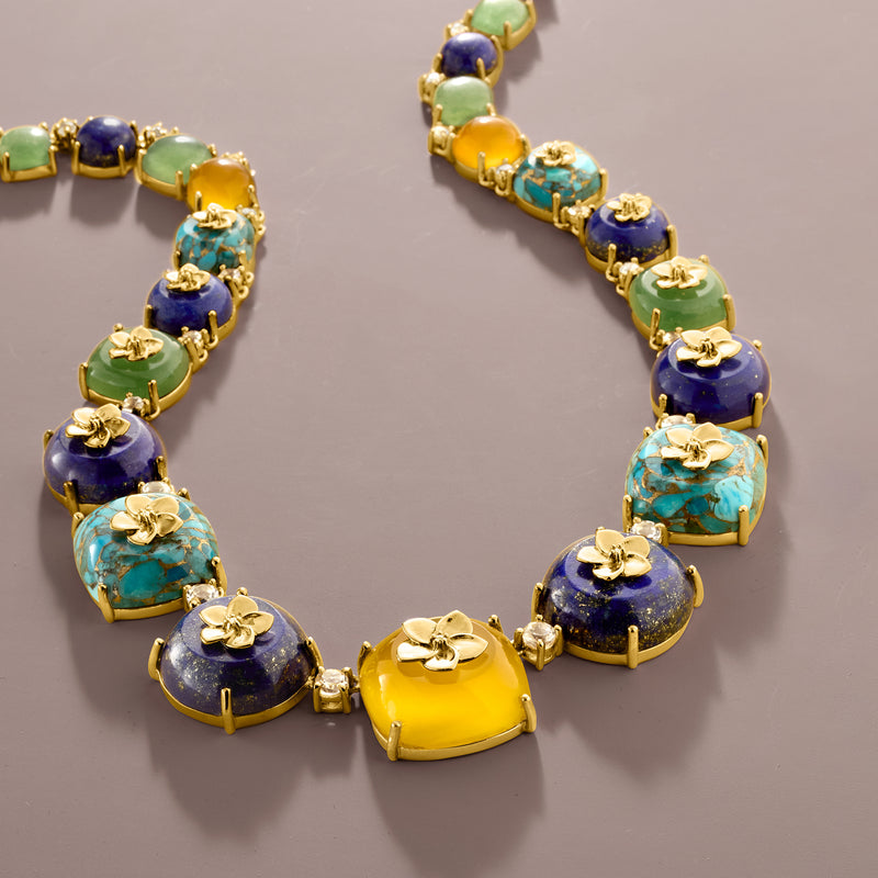 Gold-link multi-gemstone necklace close-up with blue, green, yellow, and turquoise gems