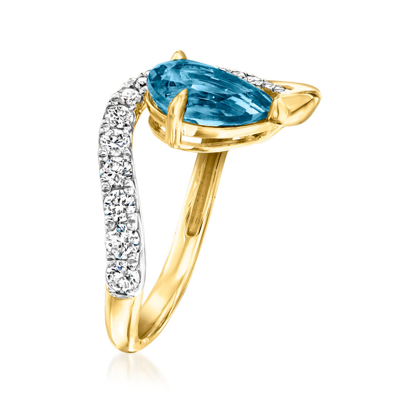 Gold teardrop blue topaz ring with white diamond side band and yellow prong setting
