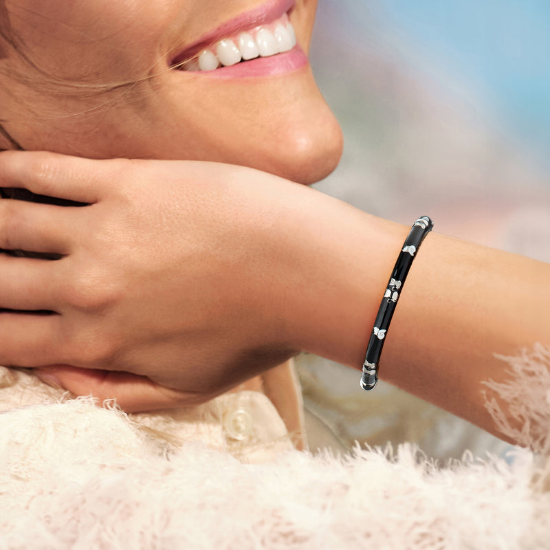 Enamel bangle bracelet with cat motifs, sterling silver, worn on wrist