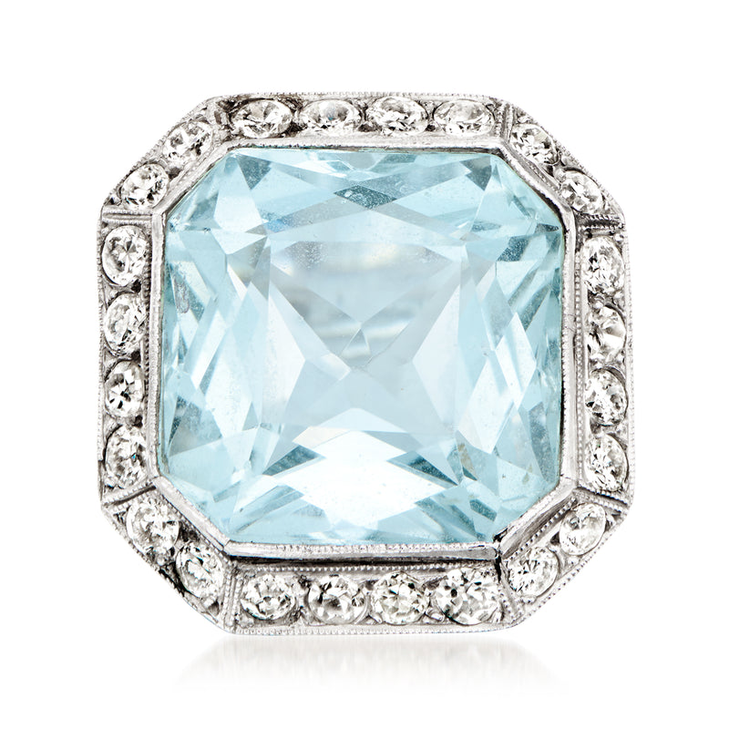 Vintage aquamarine gemstone ring with emerald-cut center, diamond halo, platinum band