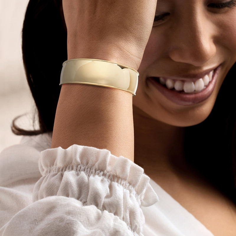 14kt yellow gold cuff bracelet on wrist, smooth polished wide band