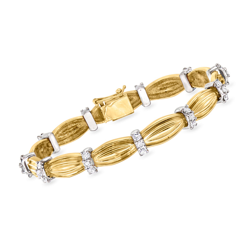 Two-tone gold diamond link bracelet with oval textured links and prong-set stones