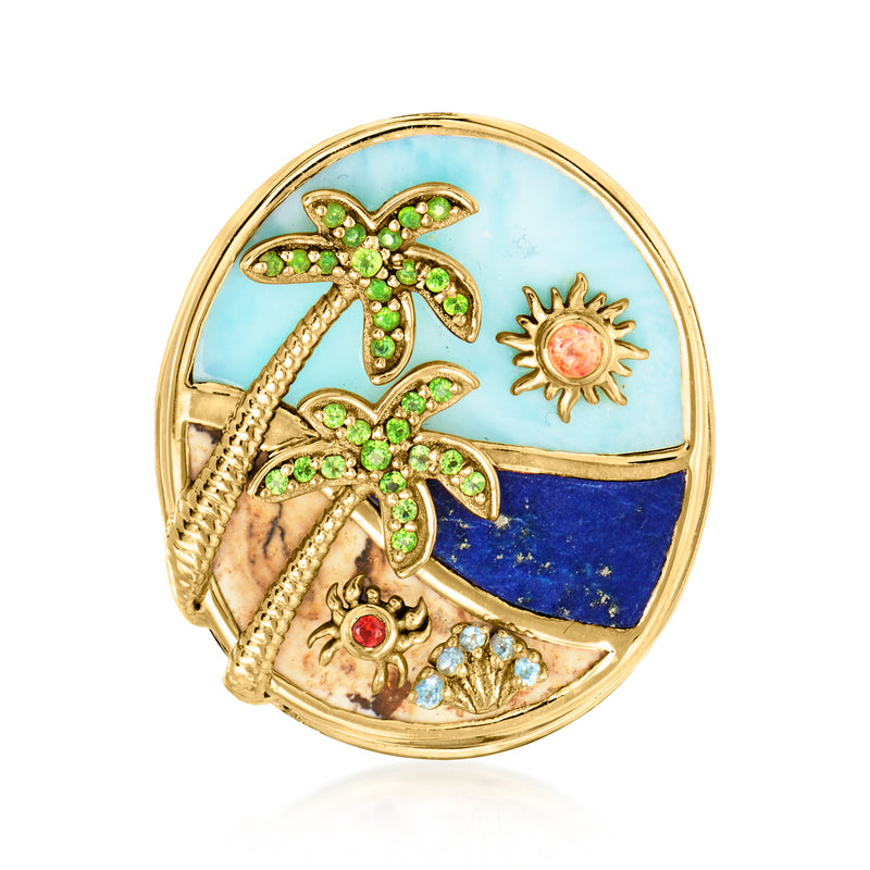 Gold-tone beach ring with palm tree, sun motif, and colorful gemstone scene in oval bezel