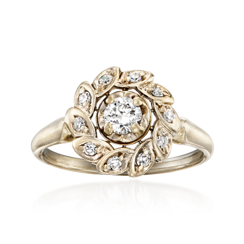 Vintage white gold diamond cluster ring with round center stone and halo, ornate bezels