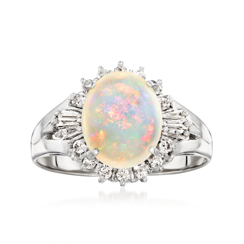 Platinum opal oval ring with diamond halo and side baguette accents