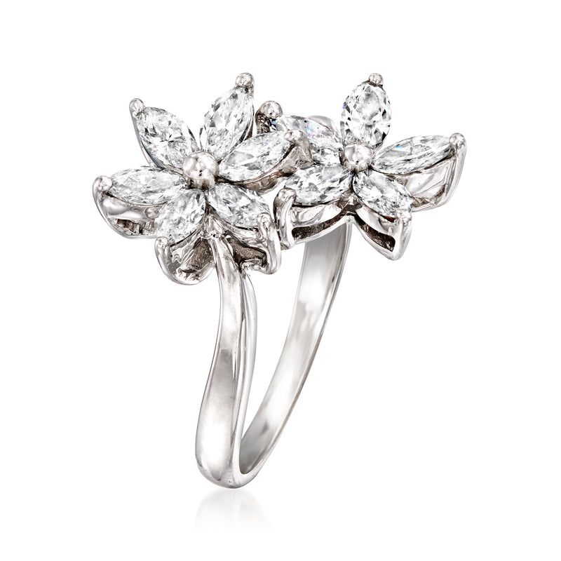Diamond flower bypass ring in 18kt white gold with marquise and round center stones.