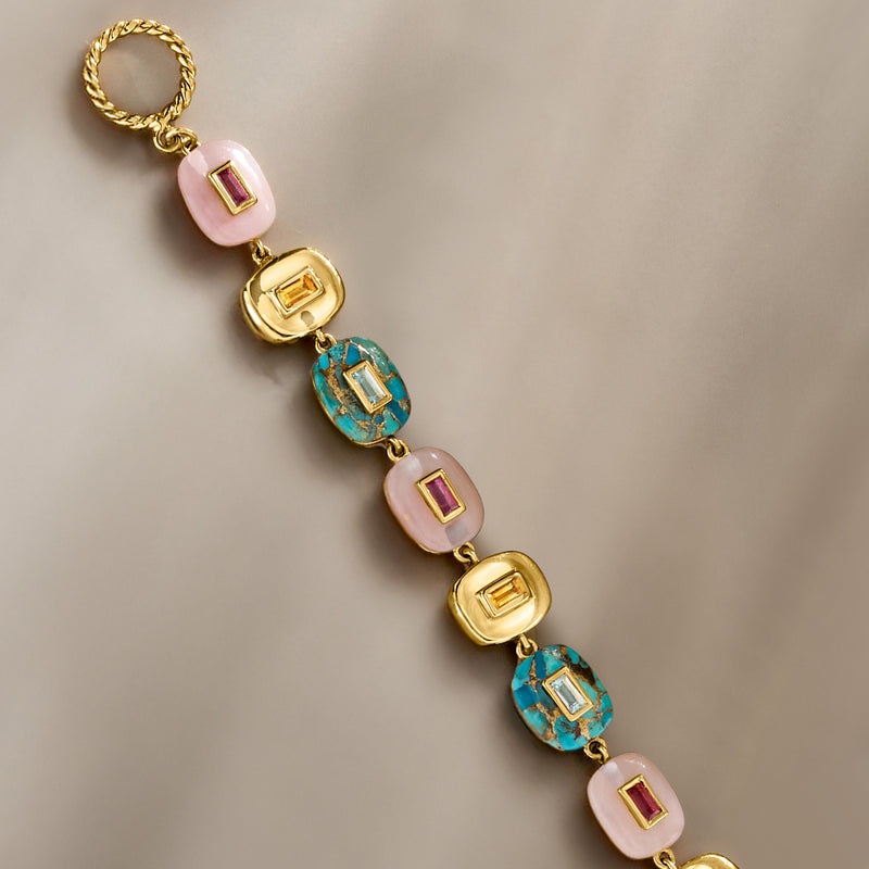 Gold-tone link bracelet with alternating pink opal and turquoise square bezel stones