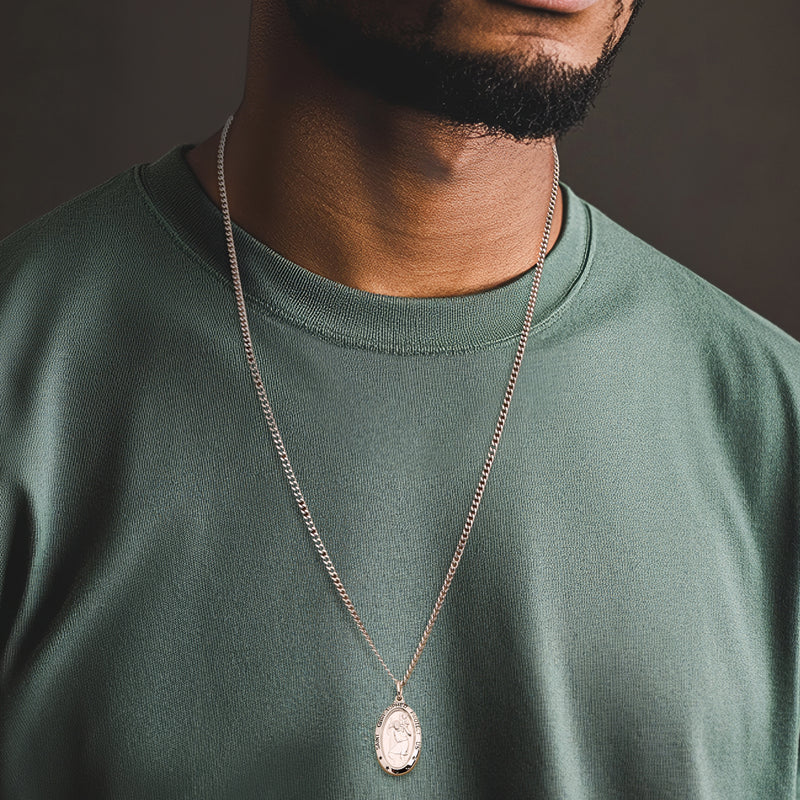 Sterling silver chain necklace with oval Saint Christopher pendant on neckline