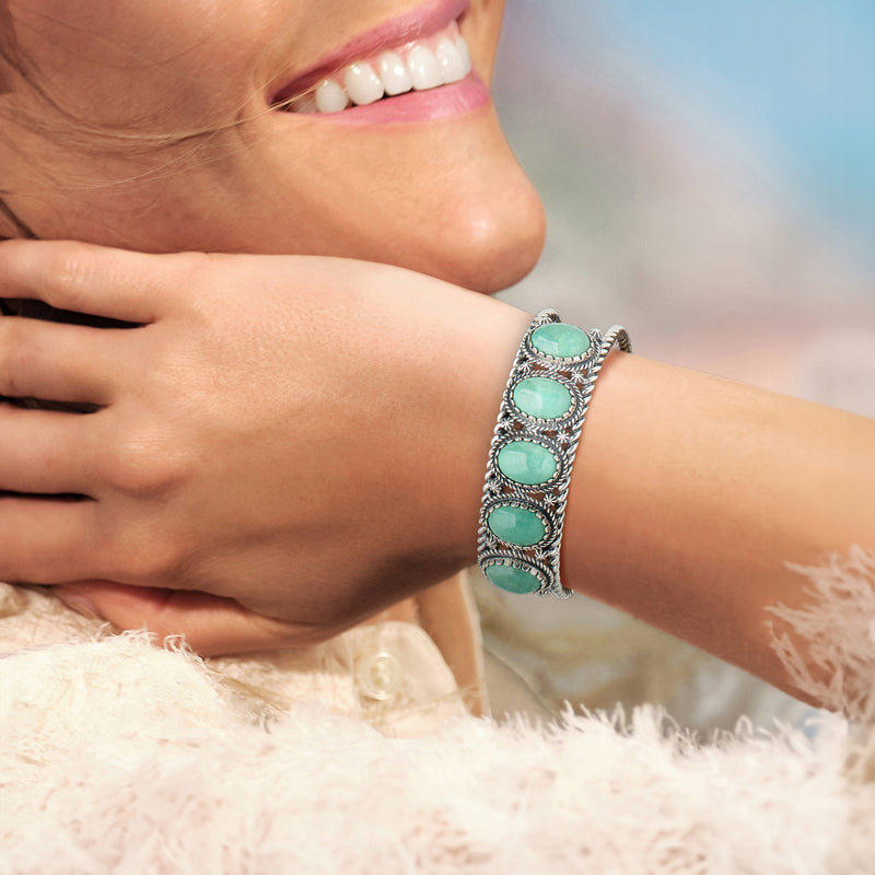 Sterling silver turquoise cuff bracelet with five oval stones on wrist
