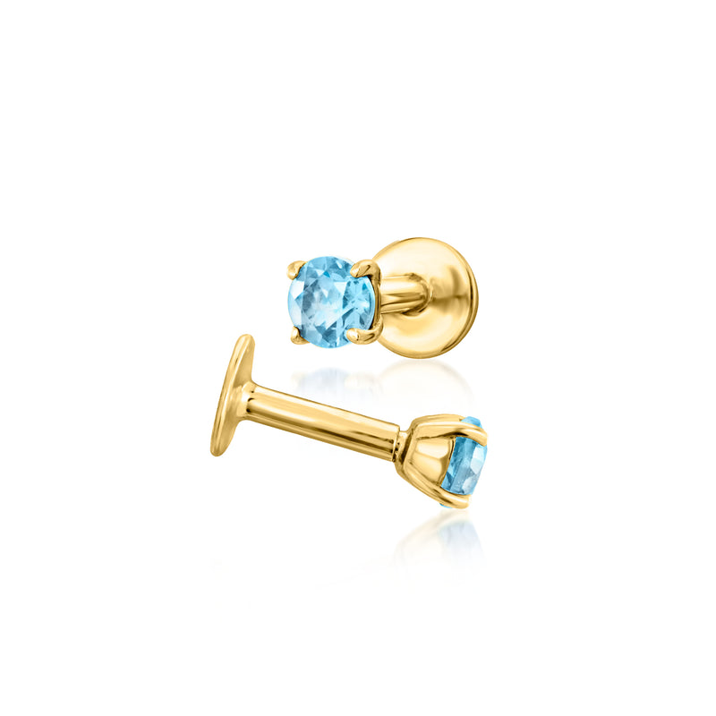 14kt yellow gold flat-back topaz stud earrings with blue stones, angled views