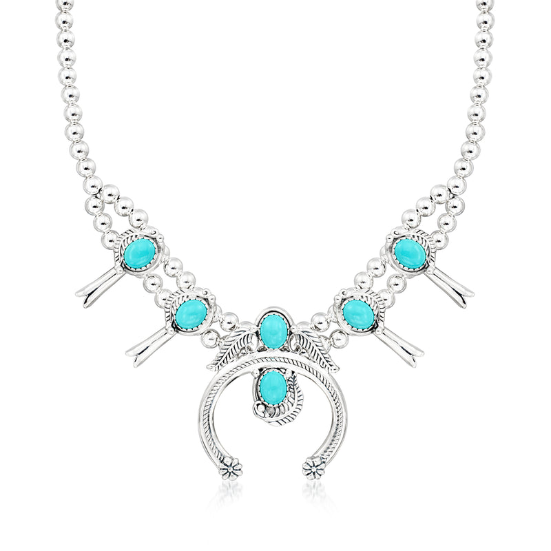 Sterling silver necklace with turquoise cabochon beads and round pendant