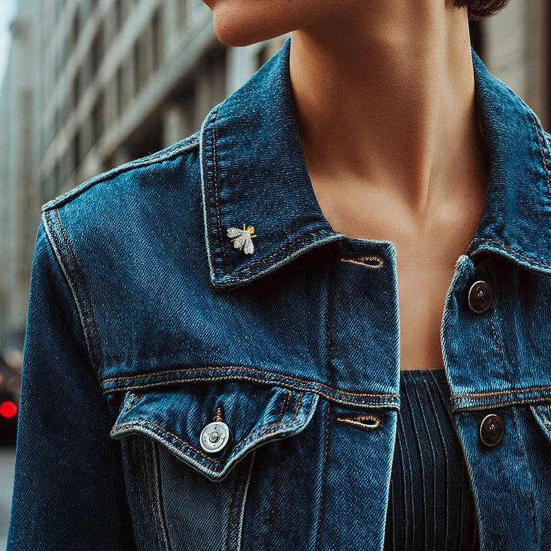 Bumblebee diamond and ruby pin on blue denim jacket collar