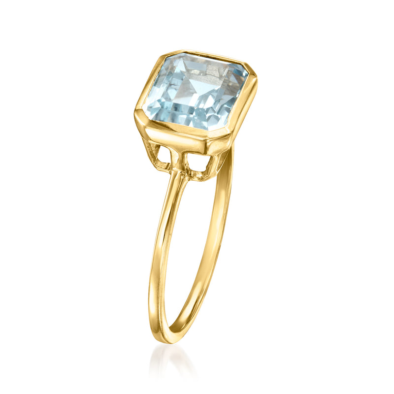 Sky-blue topaz emerald-cut ring in 14kt yellow gold, angled view of setting