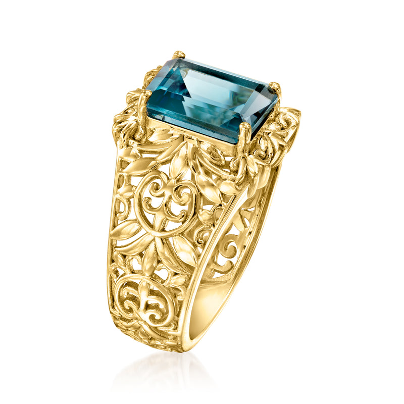 Gold filigree scroll ring with rectangular blue topaz center stone