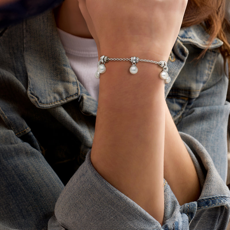 Cultured pearl station bracelet with diamond accents on wrist, silver chain with clasp