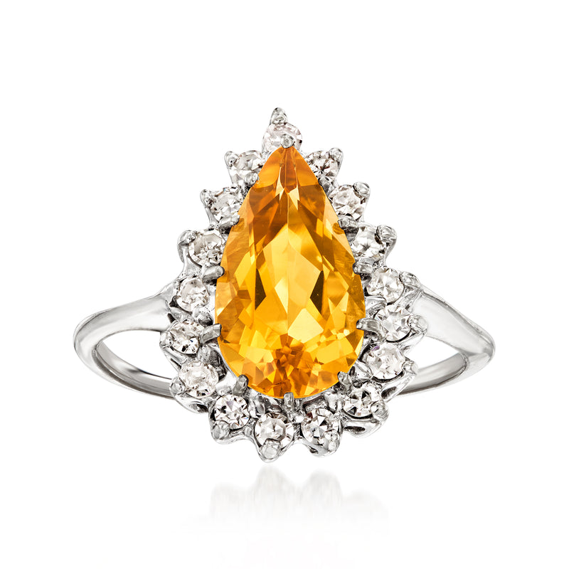 Citrine and diamond halo ring with pear-cut yellow stone in white gold.