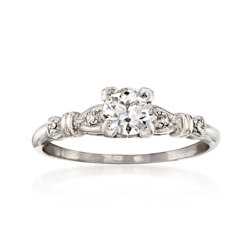 Platinum vintage diamond ring with round center stone and halo accents