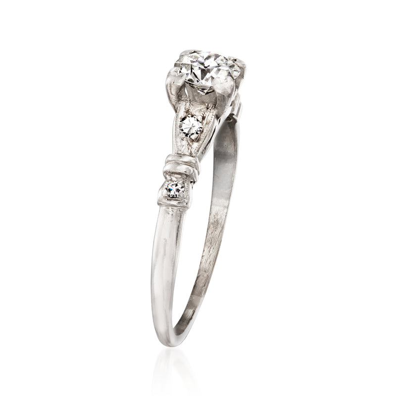 Platinum vintage diamond ring with round center stone and split shank details