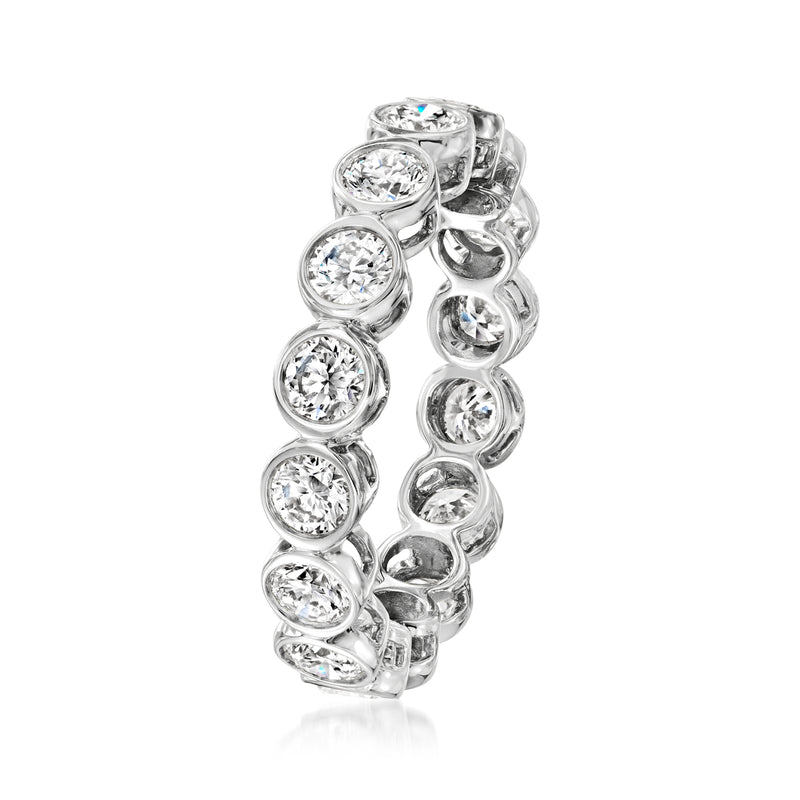 White gold diamond eternity band with round bezel-set stones in a curved side view