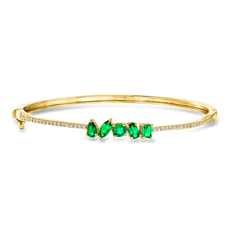 Gold bangle bracelet with green emerald stones and diamond accents