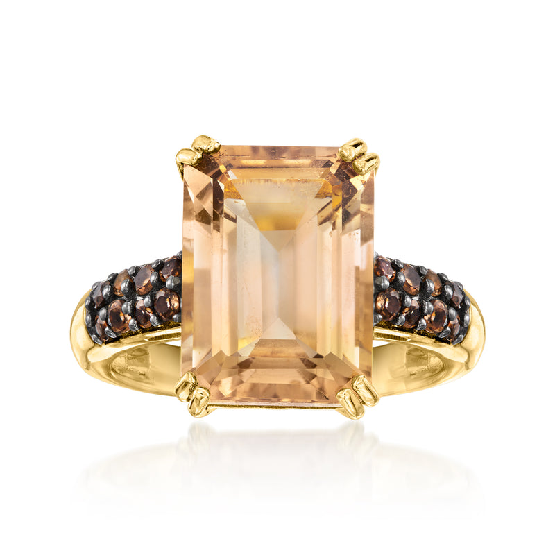 Gold ring with large rectangular smoky quartz center and black gemstone pave shoulders.