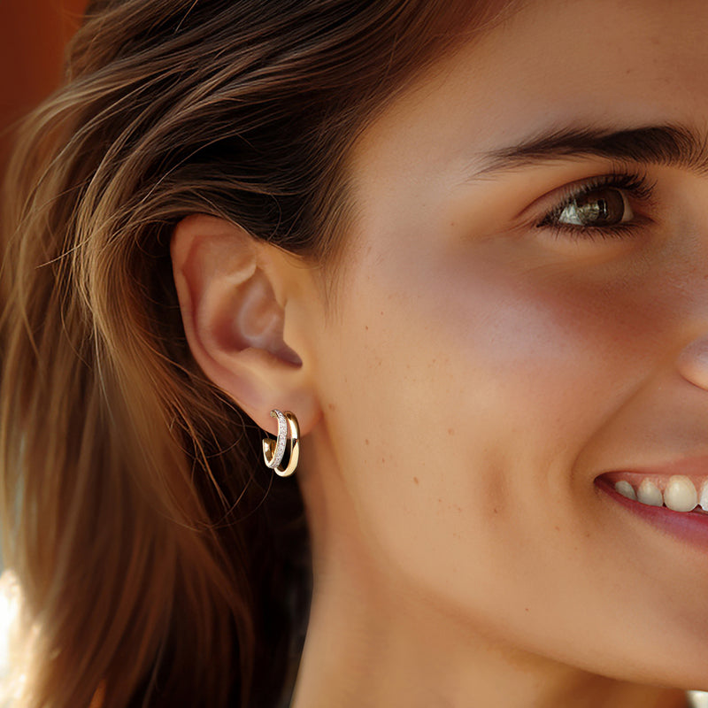 14kt yellow gold diamond double-hoop earrings on a woman's ear