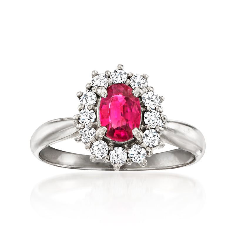 Vintage platinum ruby and diamond halo ring with oval pink center stone