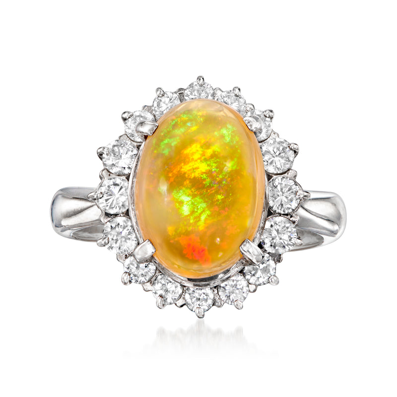 Platinum ring with oval orange-yellow fire opal center and diamond halo