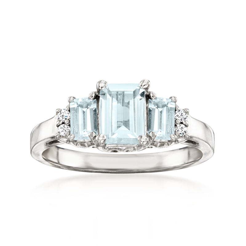 Aquamarine and diamond ring in 14kt white gold, emerald-cut center stone with side diamonds.