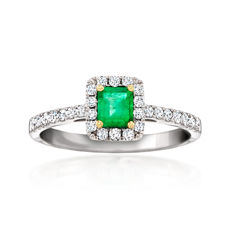 Emerald-cut green gemstone halo ring with diamond accents, set in white gold.