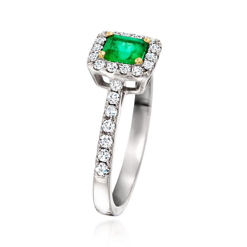 Side view of white gold ring with square emerald-cut green center and diamond band.