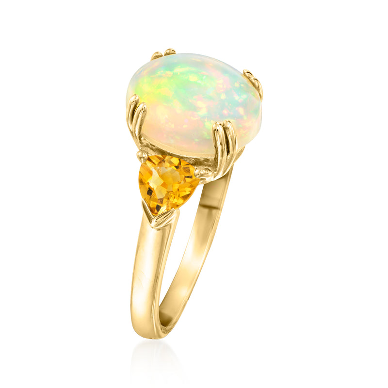 Three-stone ring with round opal center, citrine side stones, yellow gold