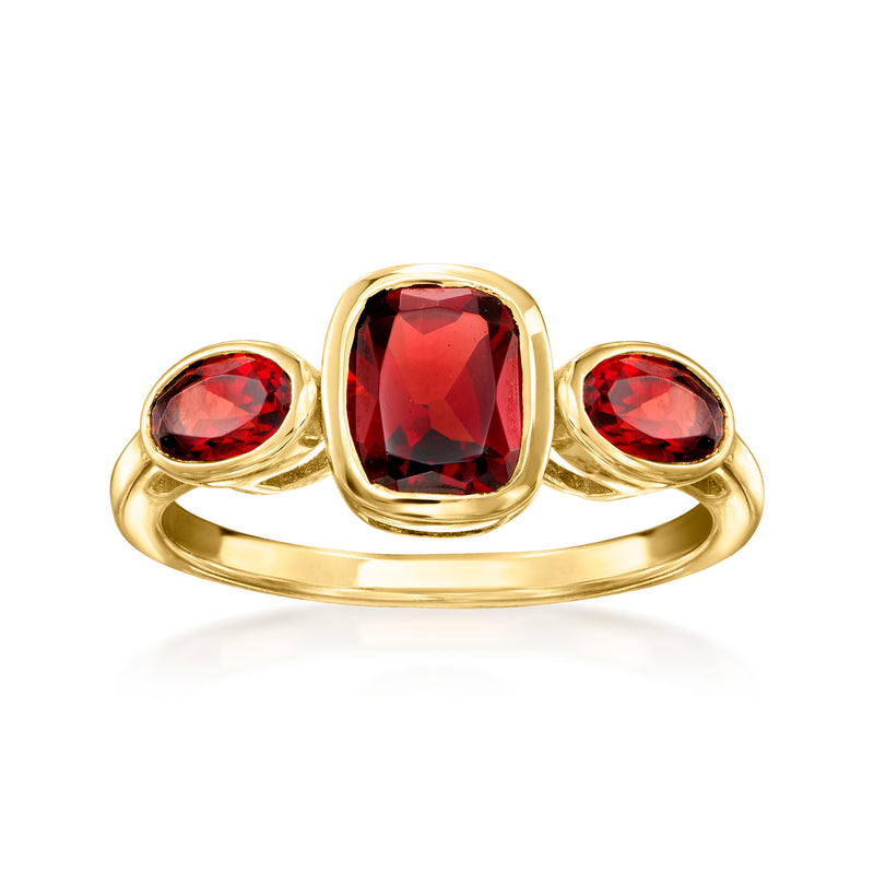 Gold three-stone ring with rectangular red center garnet and round red side stones