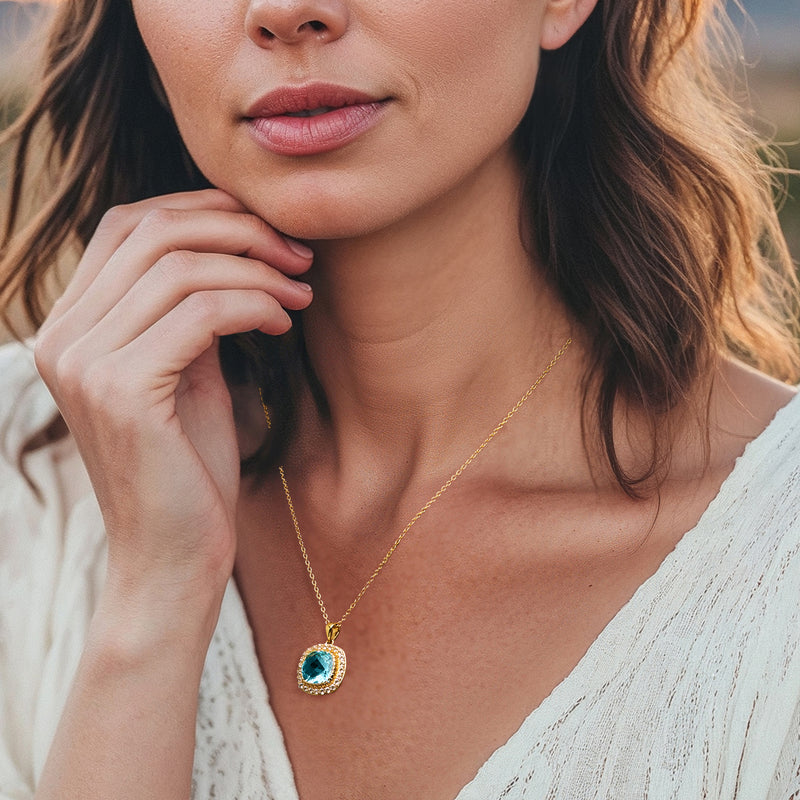 Gold-tone chain necklace with oval sky blue topaz drop and white halo