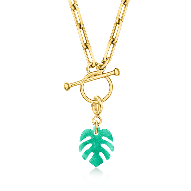 Gold chain pendant with green palm-leaf charm, close-up view