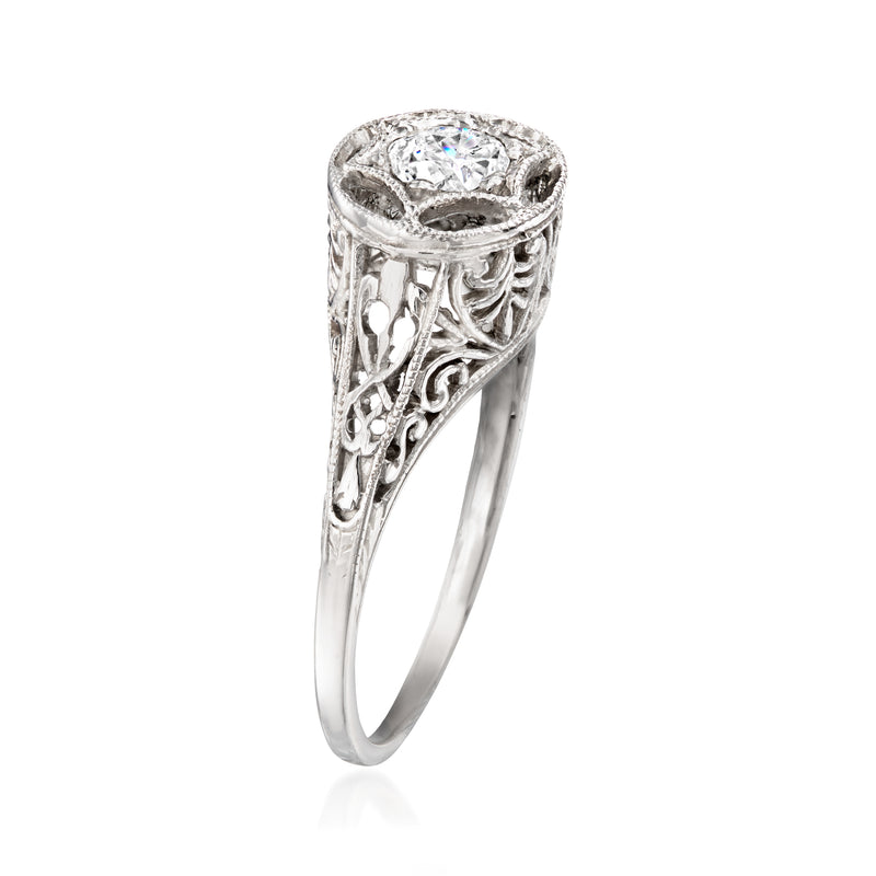 White gold filigree diamond ring with round center stone, slim side profile