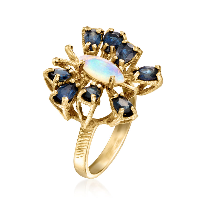 Yellow gold butterfly ring with oval opal cabochon and dark blue sapphire stones