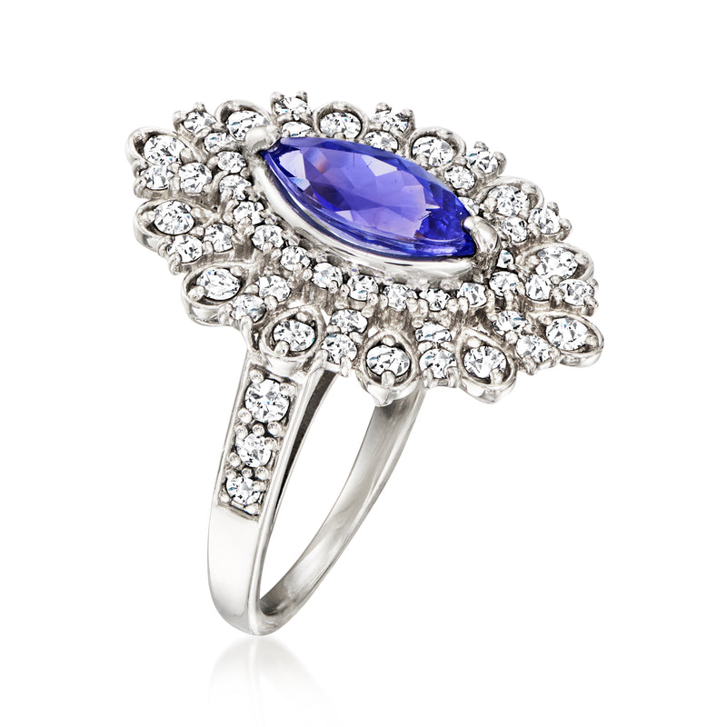 Platinum vintage ring with large oval blue gemstone and clustered diamond detailing