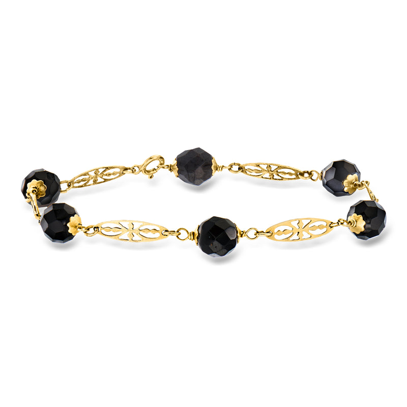 Gold station bracelet with filigree links and dark faceted onyx beads