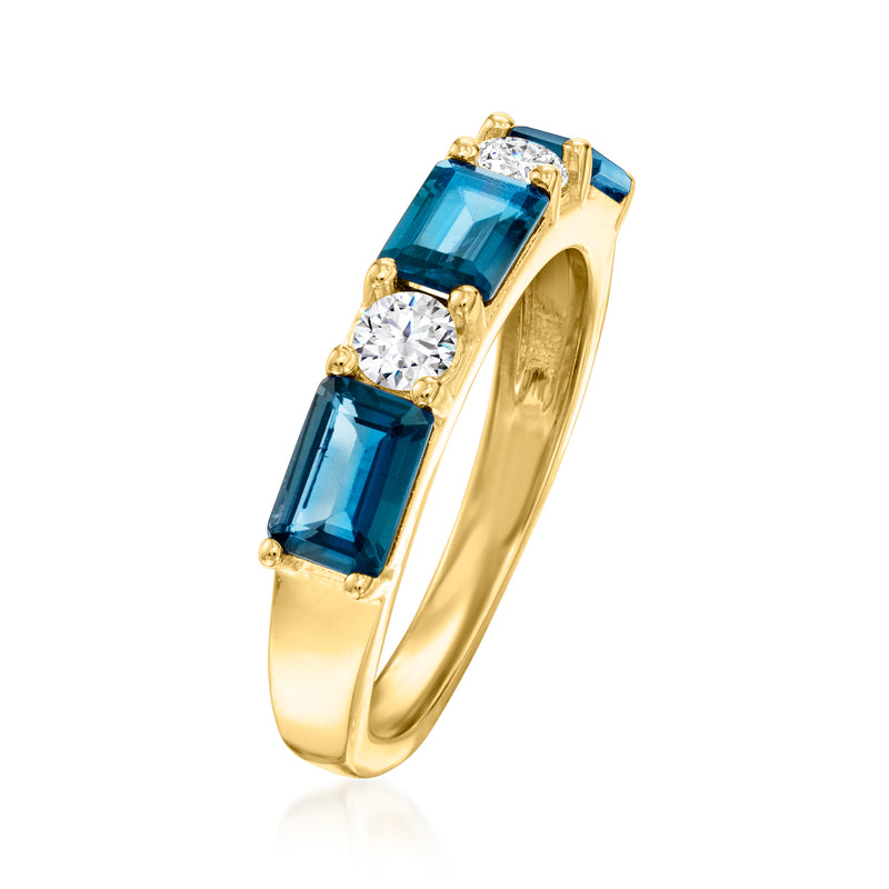 Gold ring side view with blue topaz baguettes and three round diamonds, prong-set