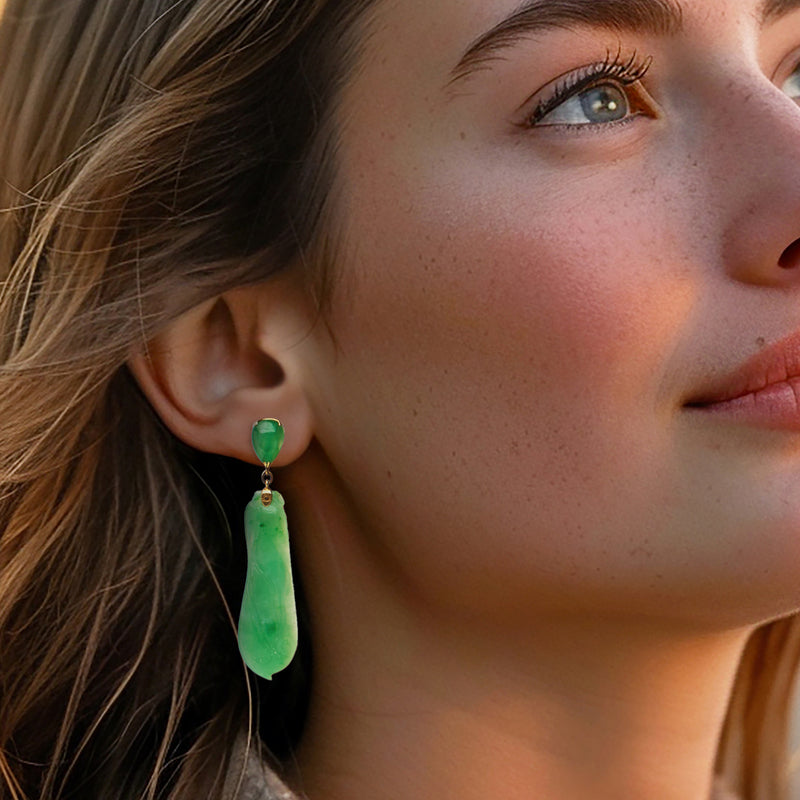 Vintage green jade drop clip earrings shown on ear, gold caps and teardrop stone