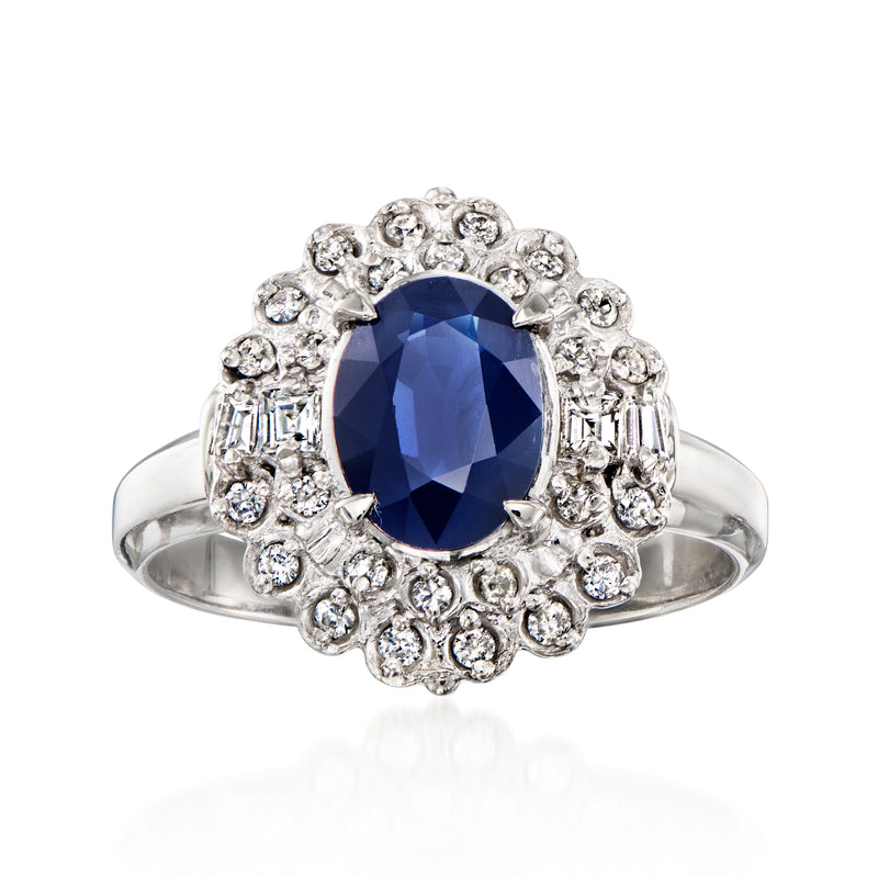 Platinum vintage sapphire ring with oval blue center stone and diamond halo